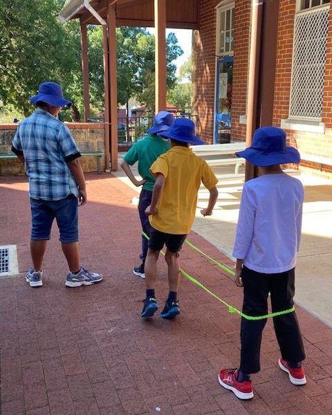 Kids jumping playing elastics