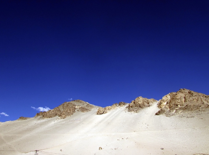 Sand dunes challenge climbing because the surface is soft.